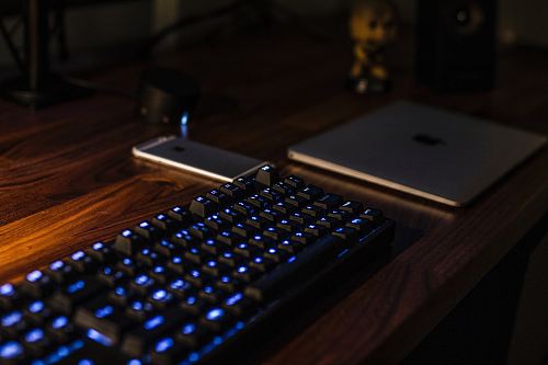 black computer keyboard on brown desk